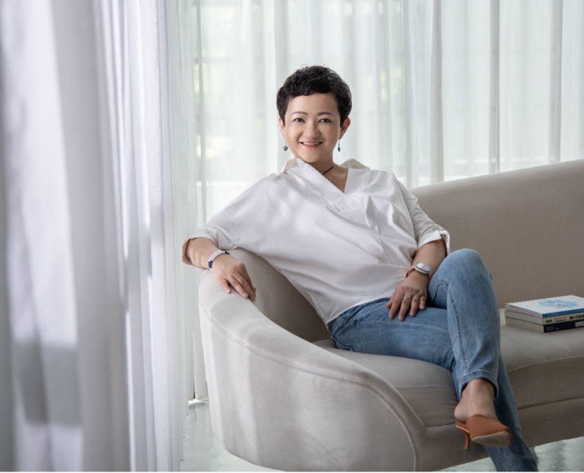 Maylin Healing sitting on a sofa