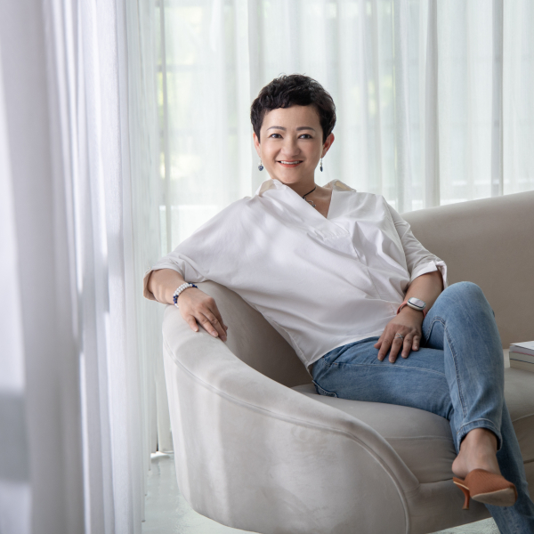 Maylin Healing sitting on a sofa